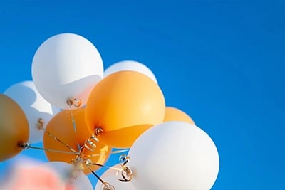 A photo of balloons representing TCWGlobals success in hitting  $426 Million in billing