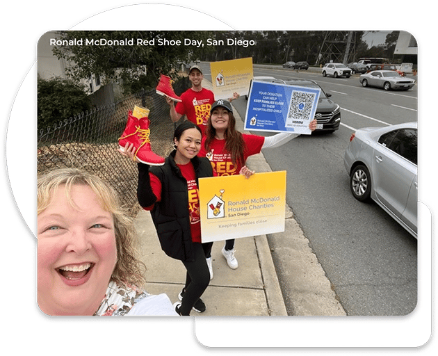 Debbie Smith, Director of Community Engagment at TCWGlobal taking a selfie with three other TCWGlobal workers. Everyone is wearing a red shirt for the Ronald McDonald House Charity