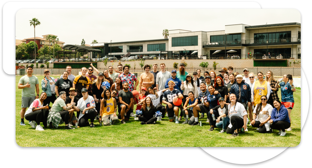 Group photo of TCWGlobal workers playing kickback. The background contains TCWGlobals office
